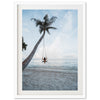 a person sitting on a swing between two palm trees