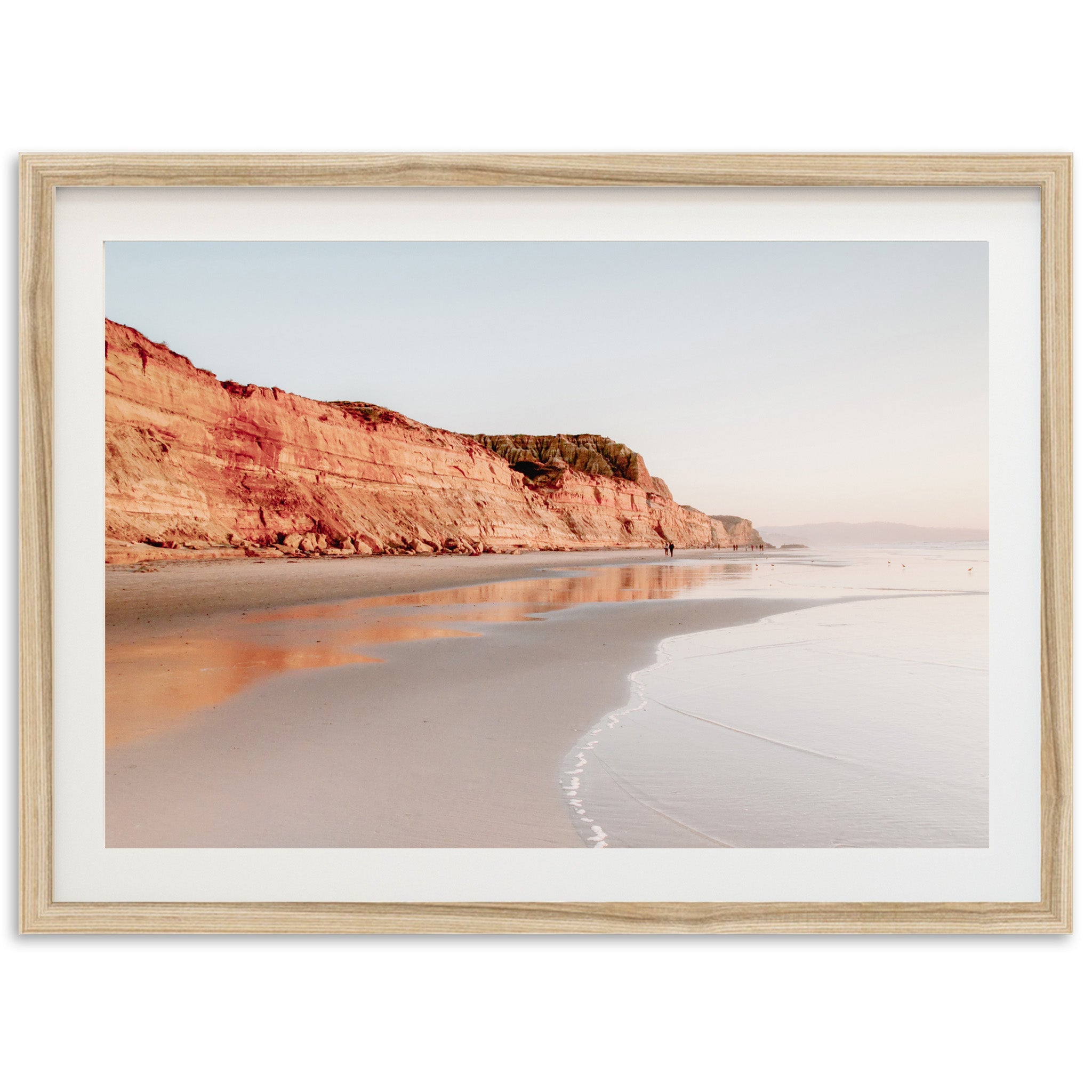 a picture of a beach with a cliff in the background