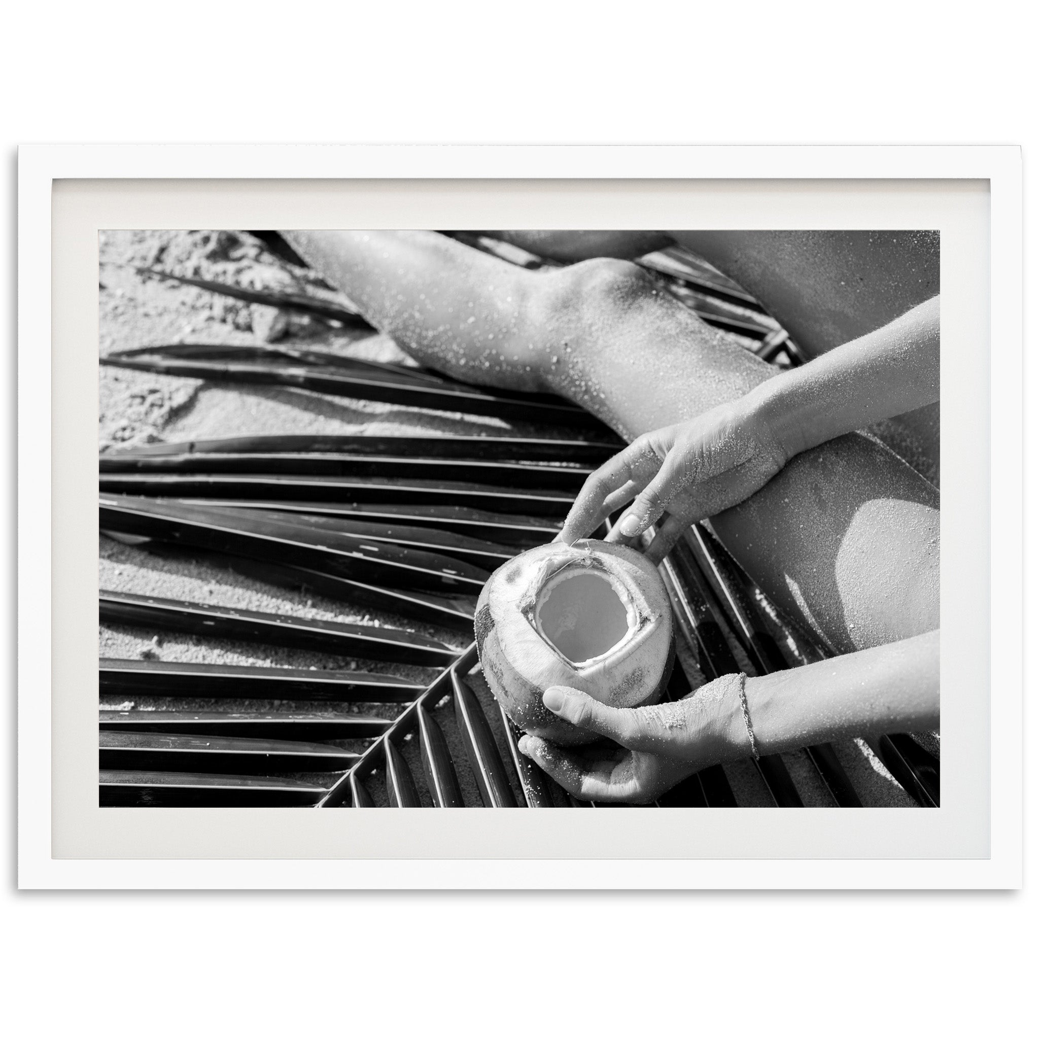 a black and white photo of a person holding a cup