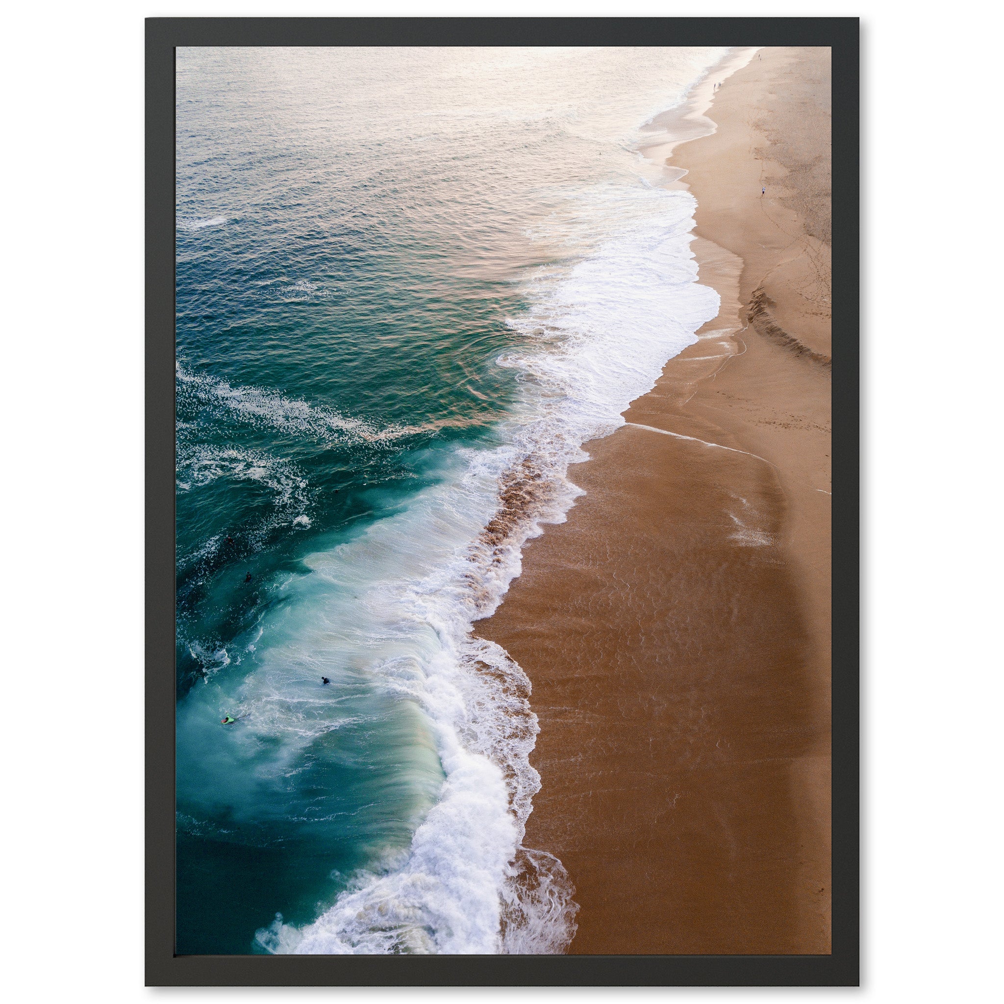 an aerial view of a beach with a wave coming in