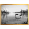 a black and white photo of a person doing a handstand in the water