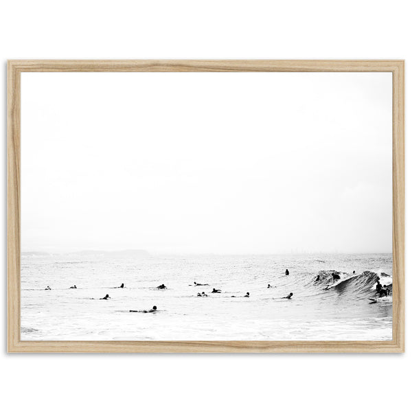 a black and white photo of surfers in the ocean