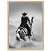 a black and white photo of a cowboy on a horse