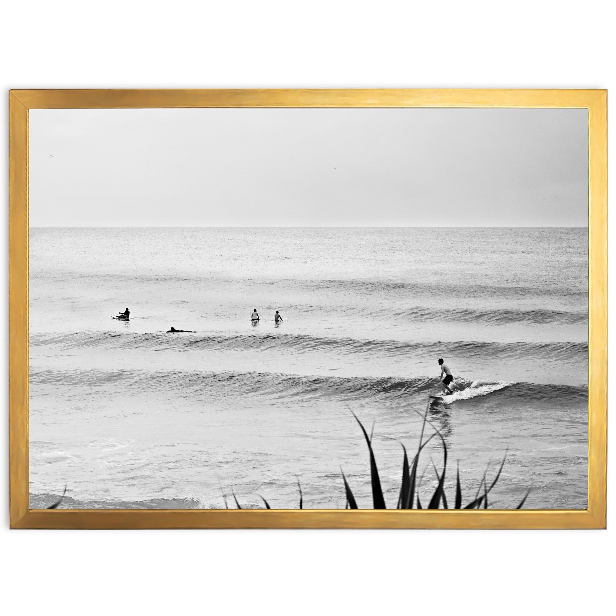 a black and white photo of surfers in the ocean