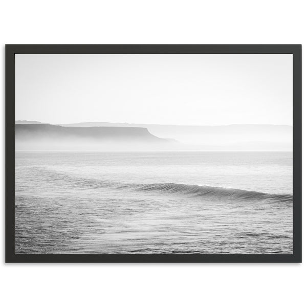 a black and white photo of a wave in the ocean