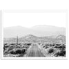 a black and white photo of a road in the desert