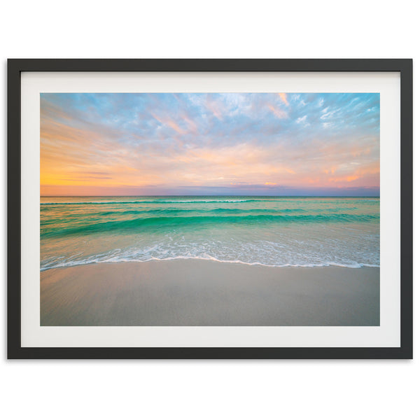 a picture of a beach with a sunset in the background