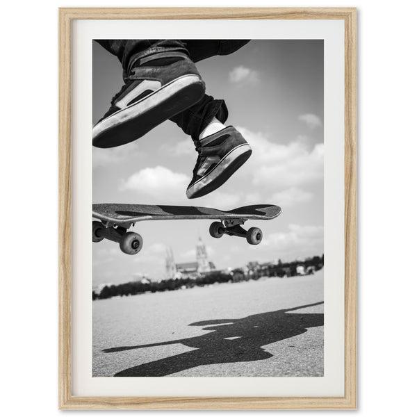 a black and white photo of a skateboarder doing a trick