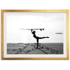 a man holding a surfboard over his head on a beach