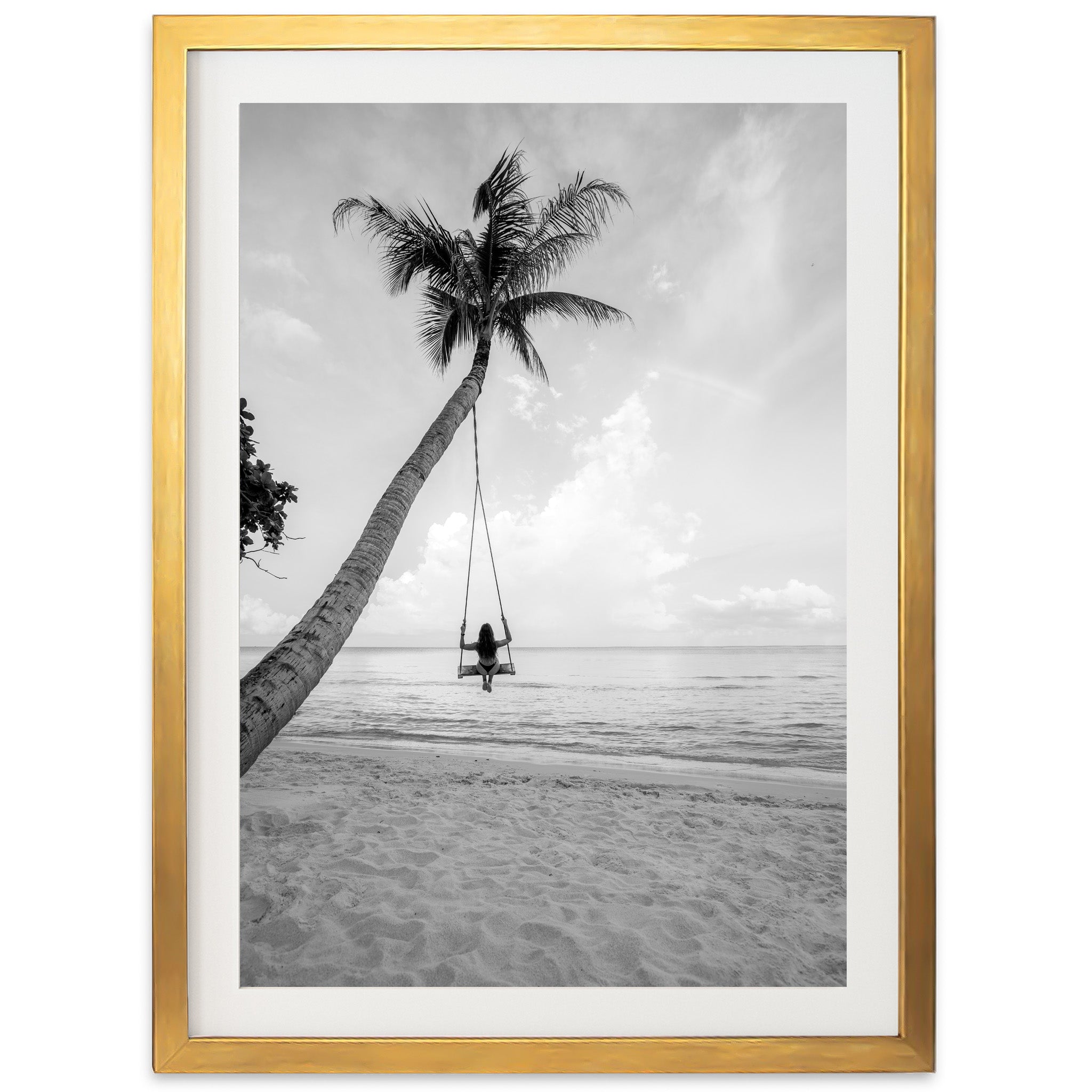 a black and white photo of a person sitting on a hammock on a