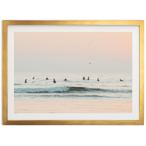 a group of people riding surfboards on top of a wave