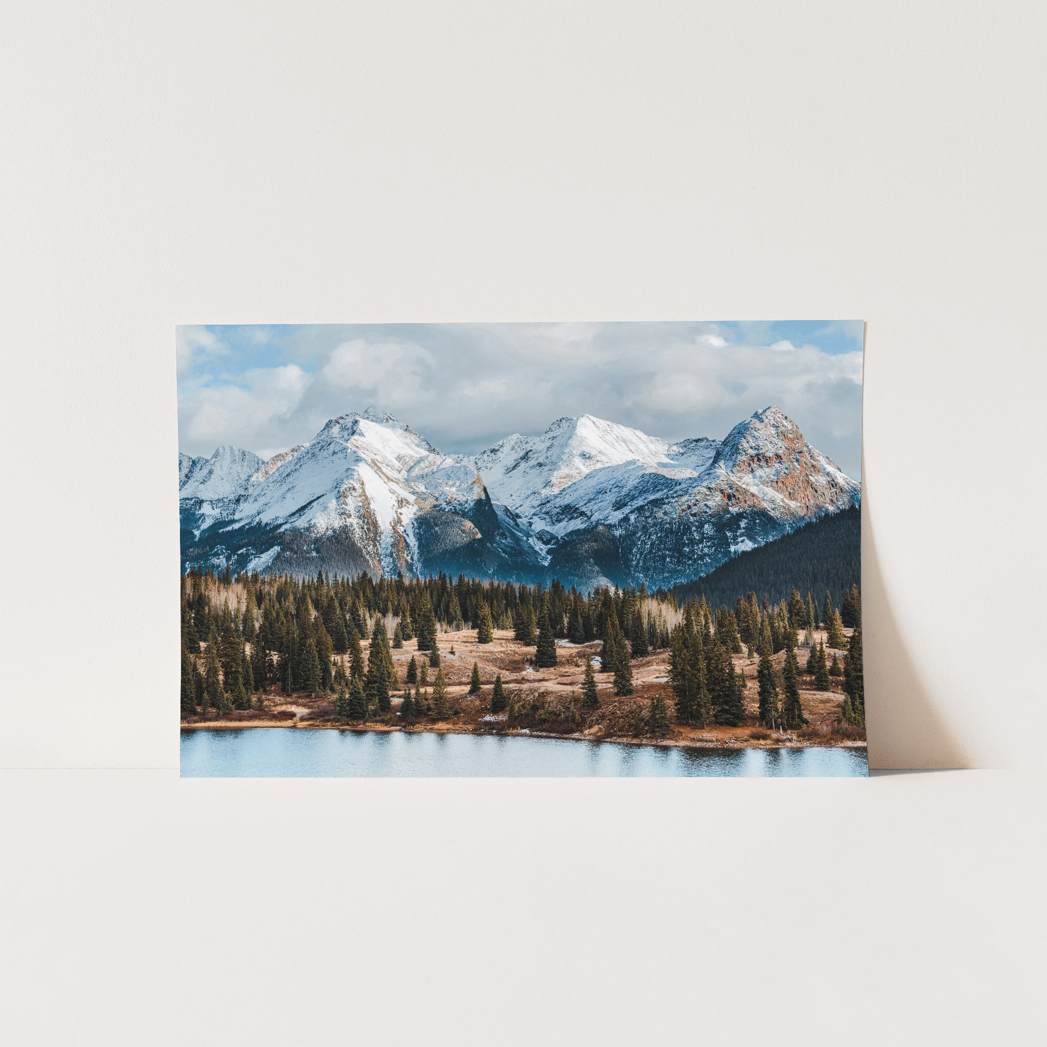 a picture of a mountain range with a lake in the foreground