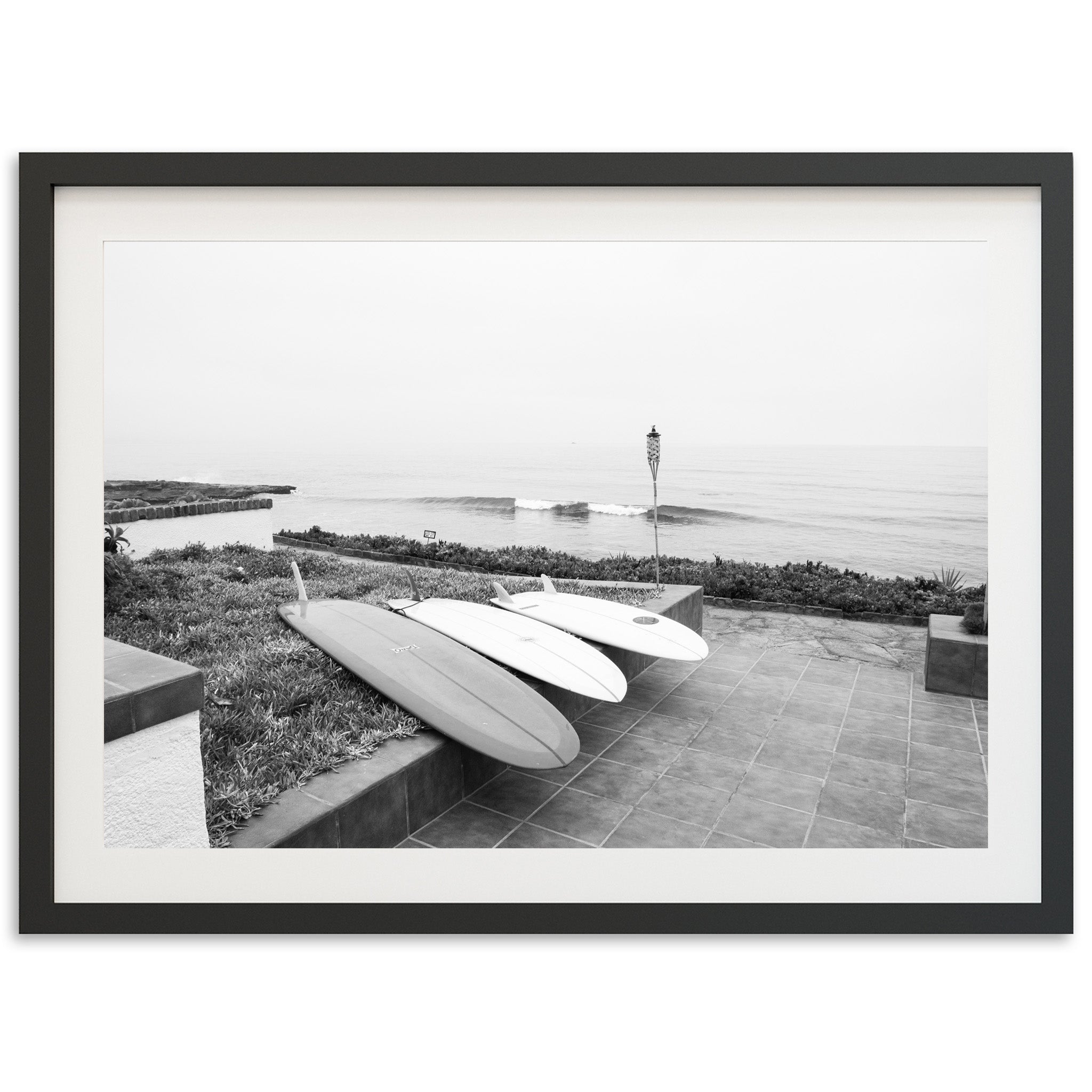 a black and white photo of two surfboards