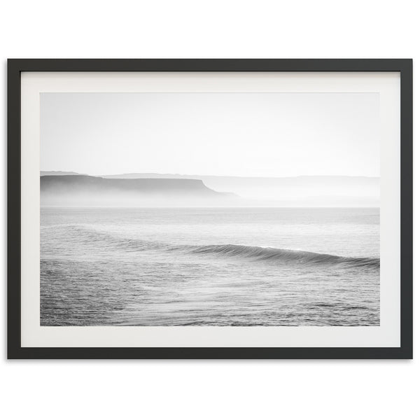 a black and white photo of a wave in the ocean