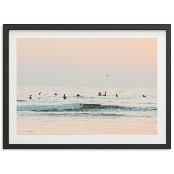 a group of people riding surfboards on top of a wave