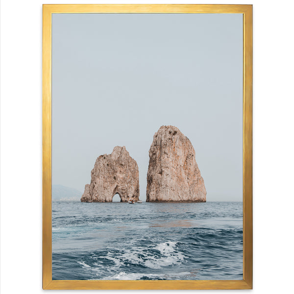 a picture of two rocks in the ocean