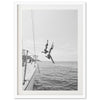 a black and white photo of a person jumping off a boat