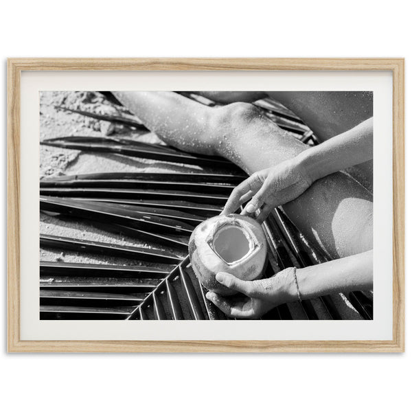 a black and white photo of a person holding a cup