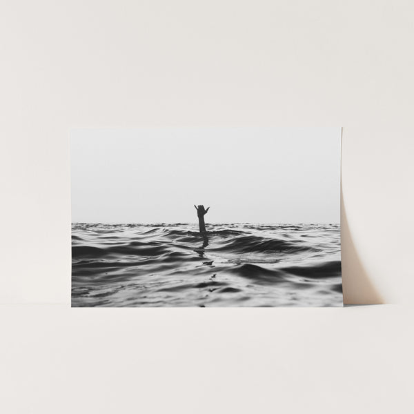 a black and white photo of a person on a surfboard