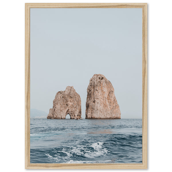 a picture of two rock formations in the ocean