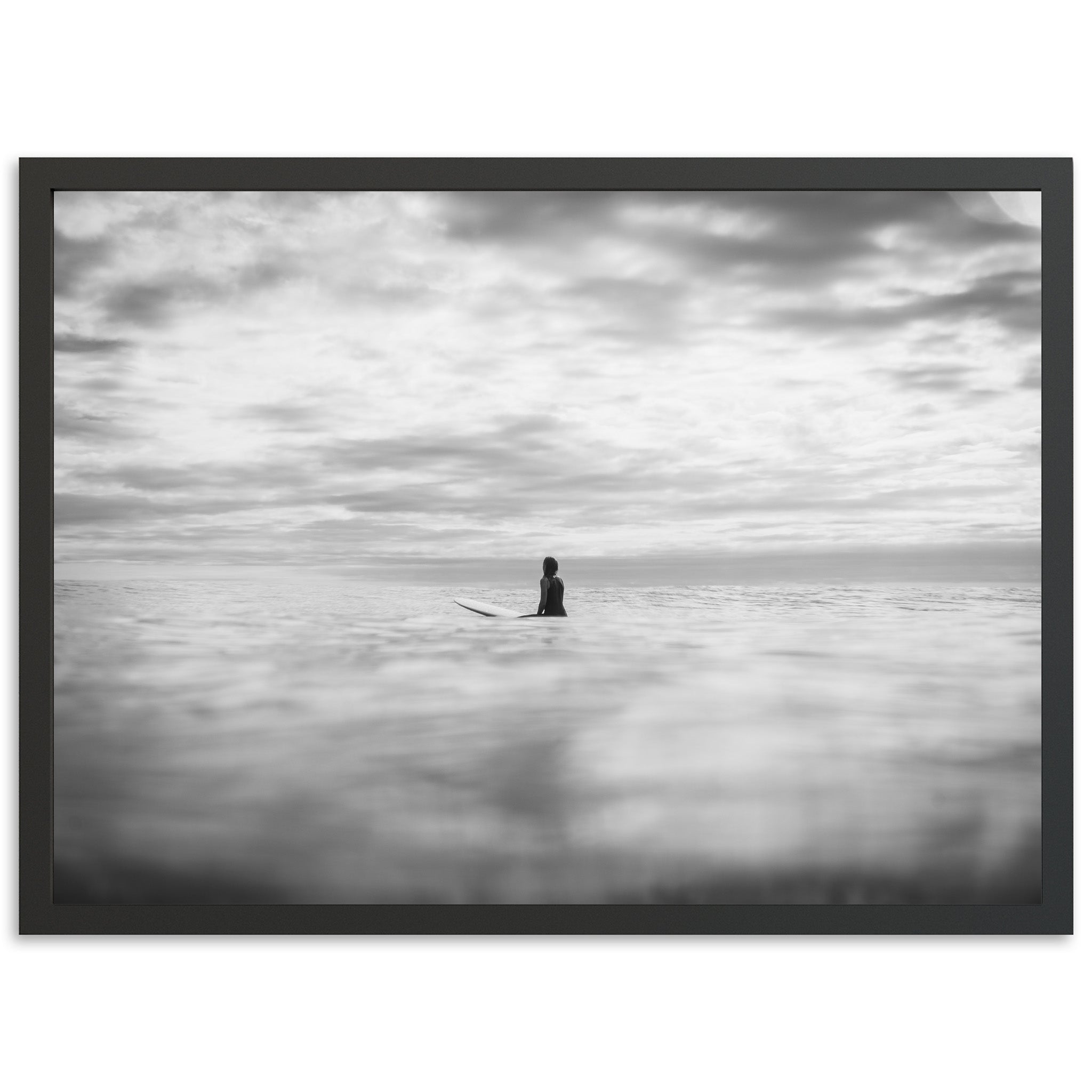 a black and white photo of a person on a surfboard