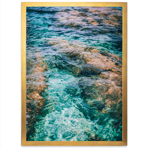 a picture of water and rocks with a gold frame