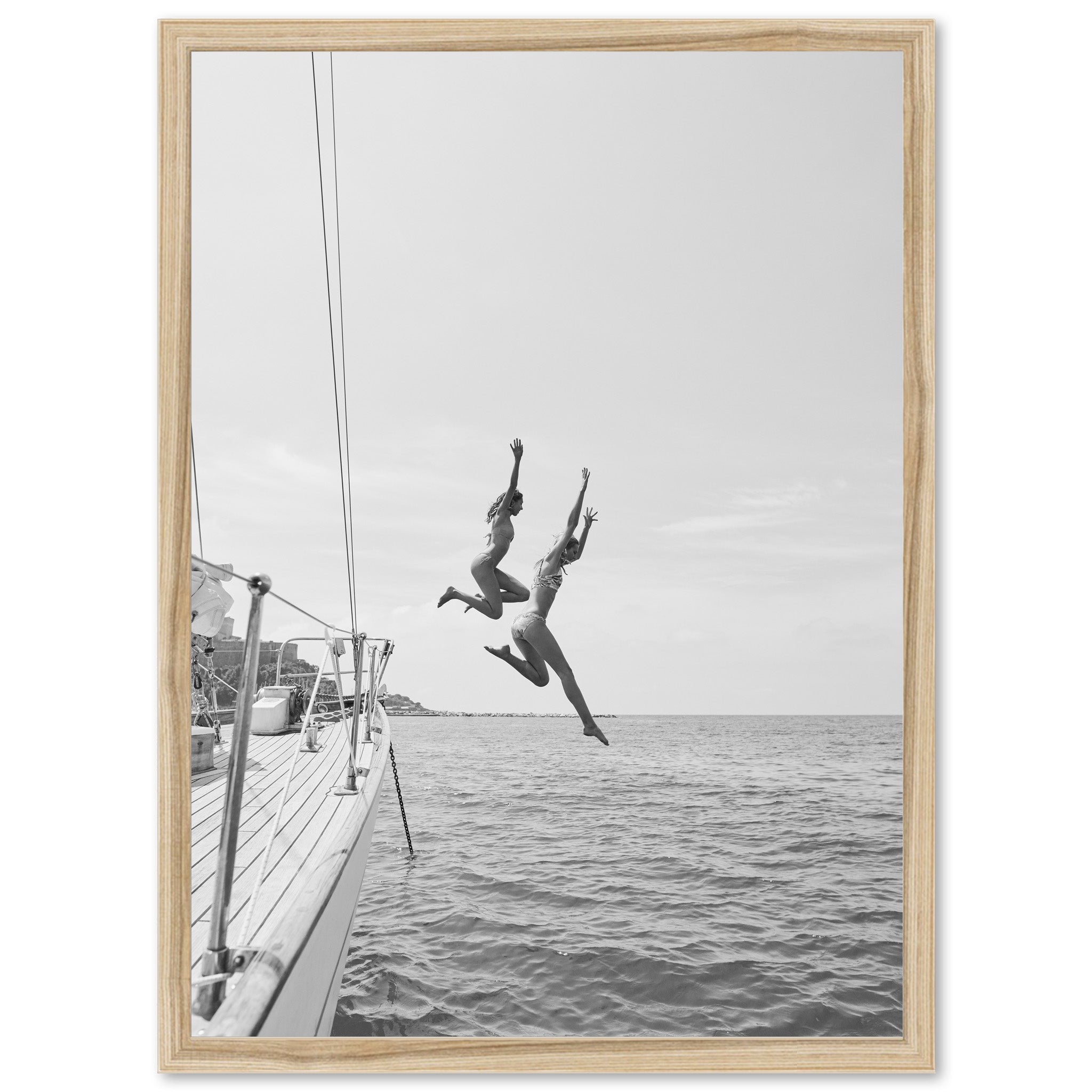 two people jumping off a boat into the water