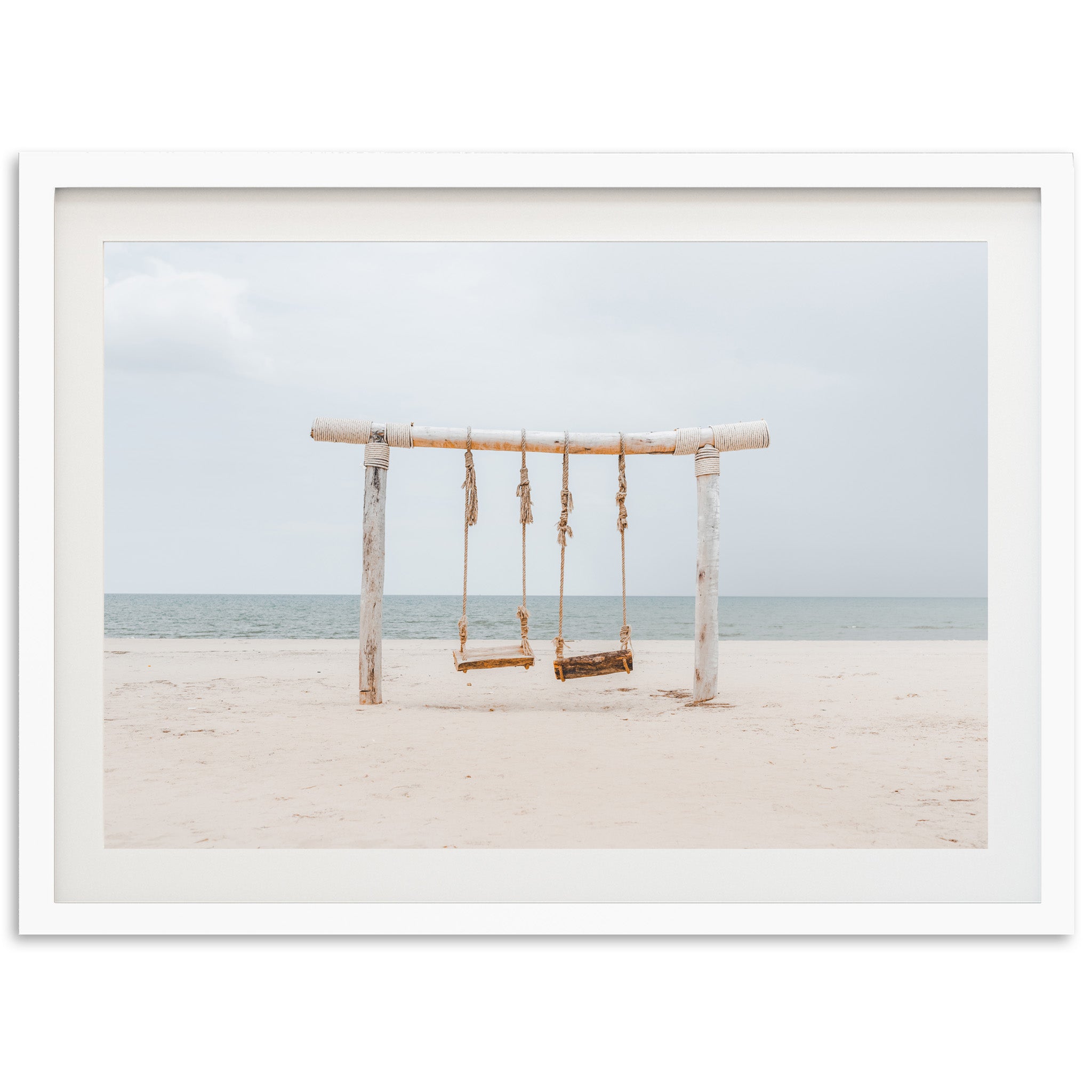 a picture of a swing on the beach