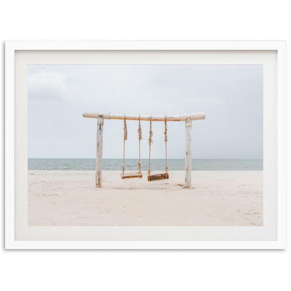 a picture of a swing on the beach