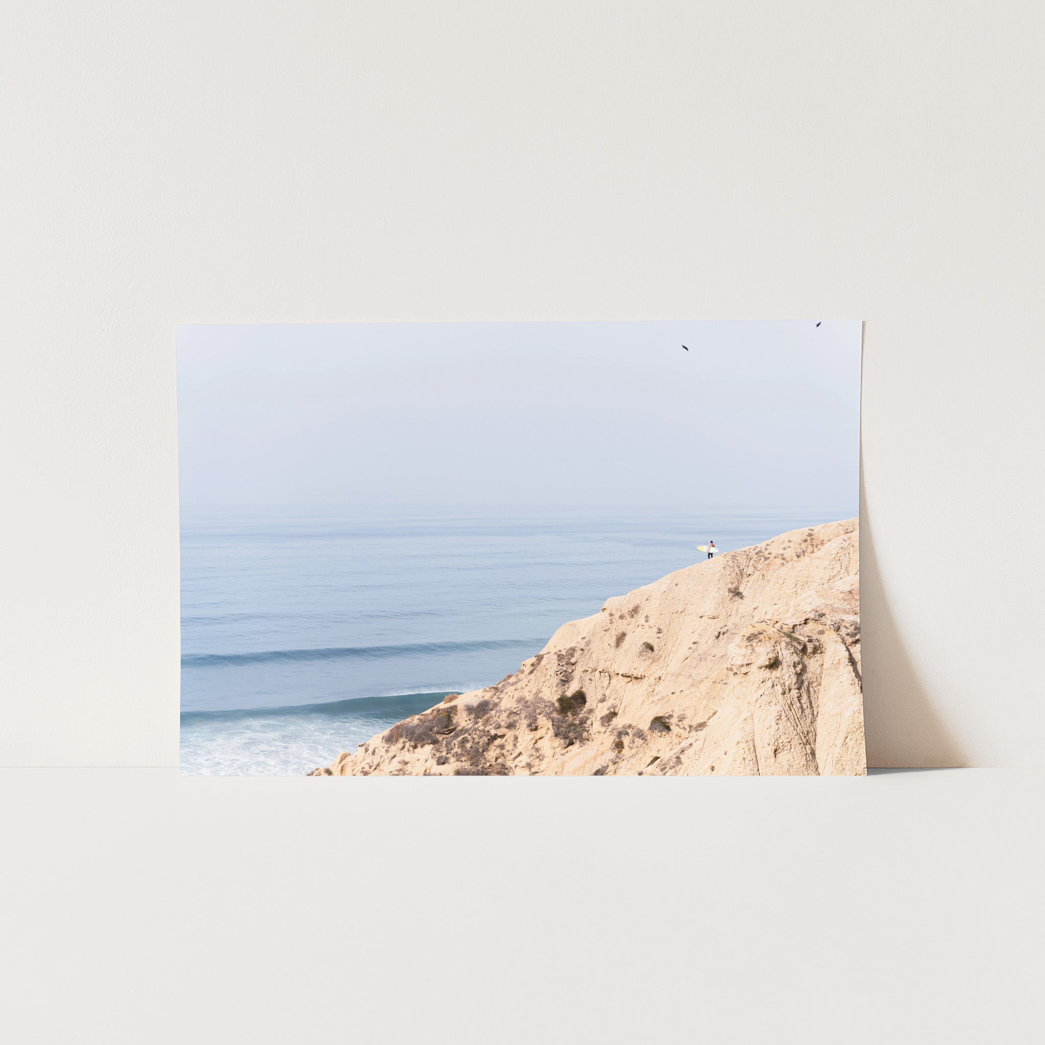 a picture of a beach with a person on a surfboard