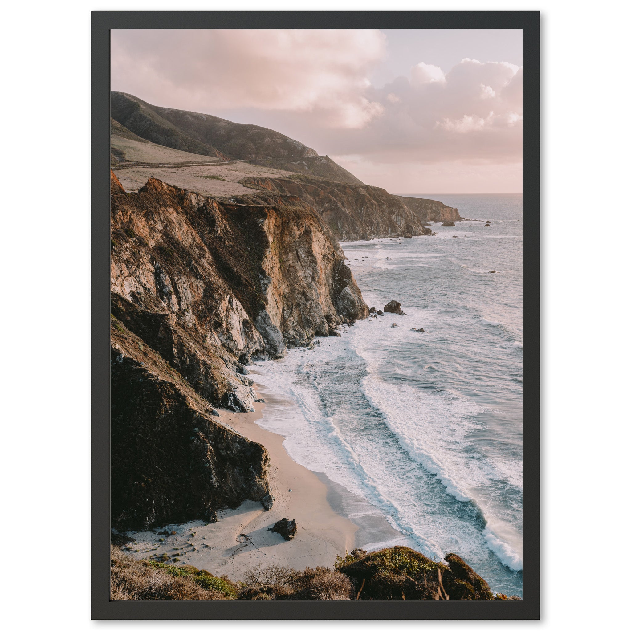 a picture of a beach with a cliff in the background