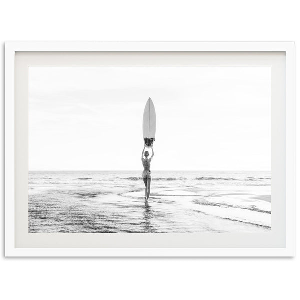 a person holding a surfboard standing in the ocean