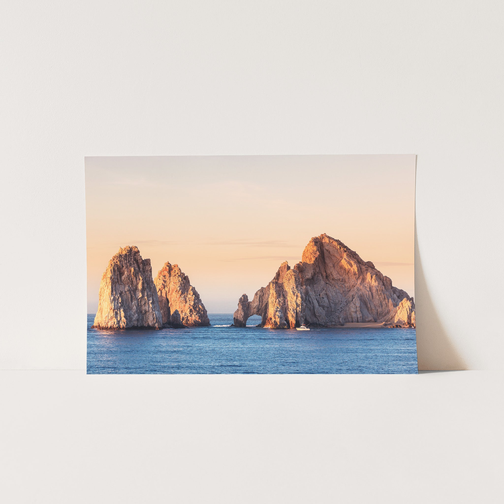 a card with a picture of three rock formations in the ocean