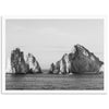 a black and white photo of rocks in the ocean