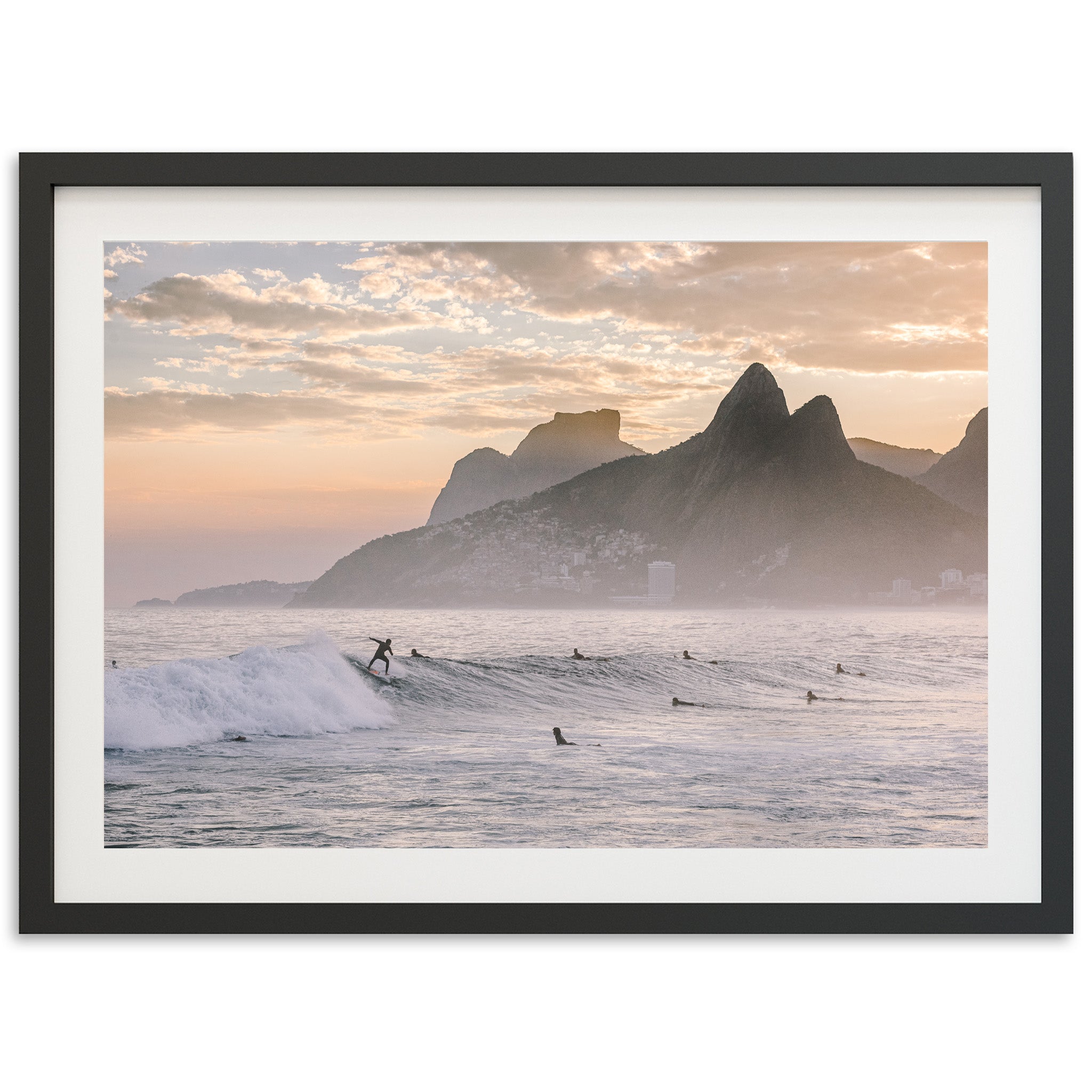 a surfer riding a wave in the ocean with mountains in the background