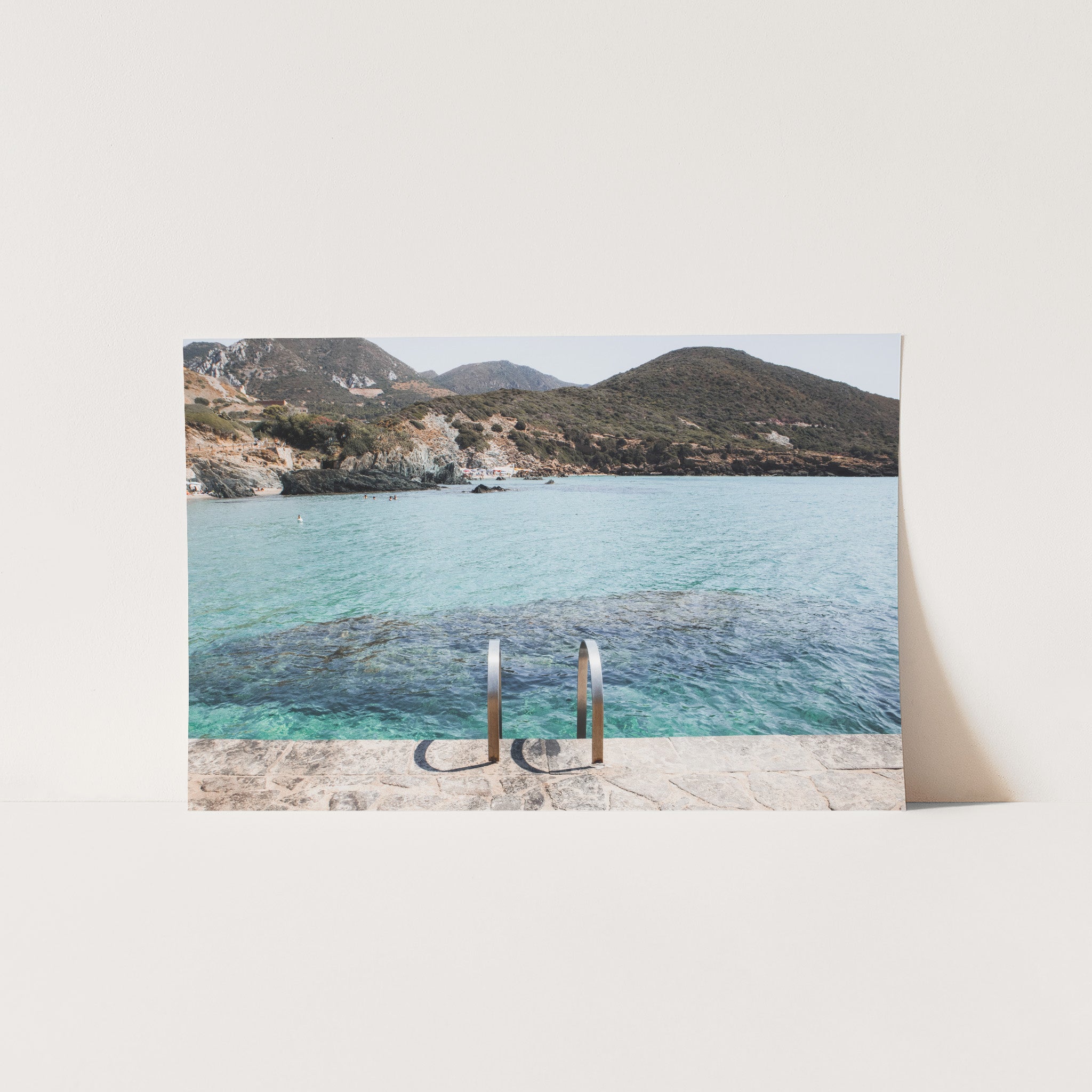 a picture of a beach with two poles sticking out of the water