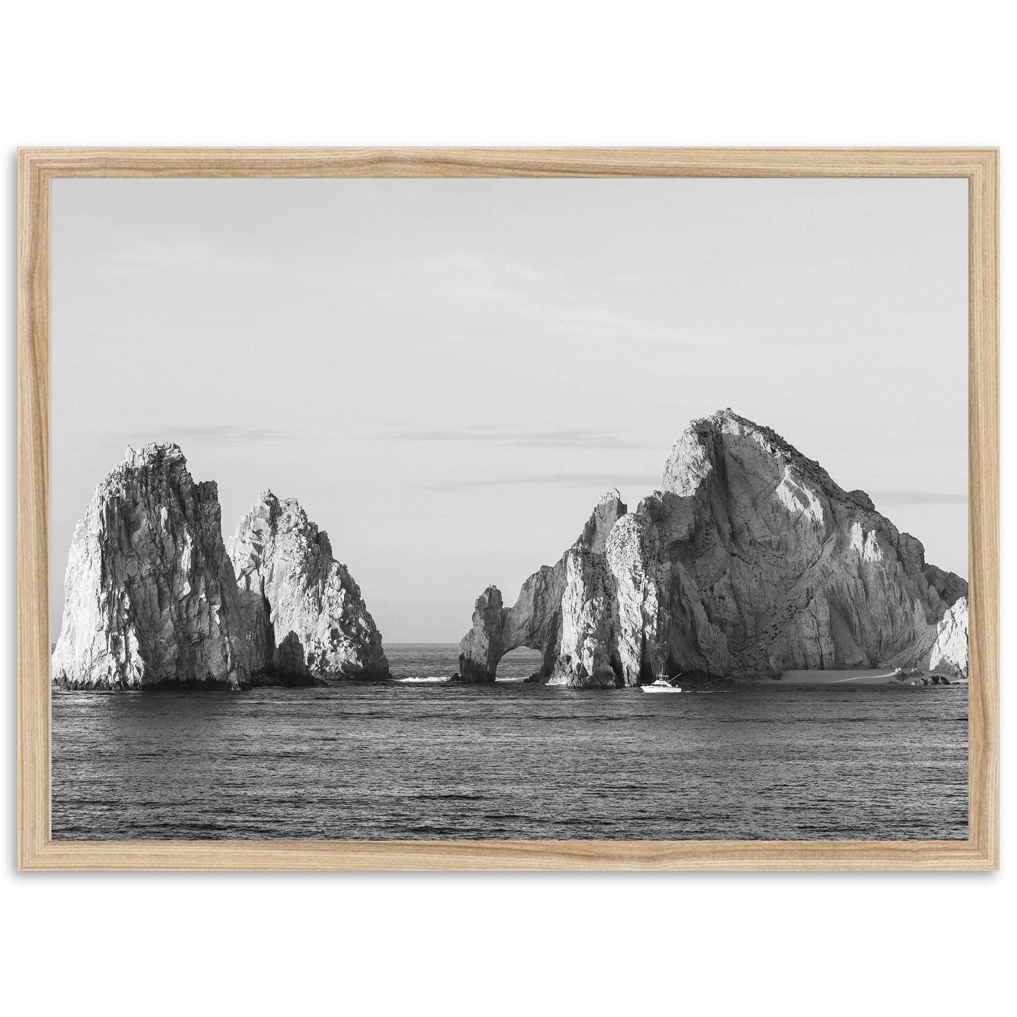 a black and white photo of rocks in the ocean