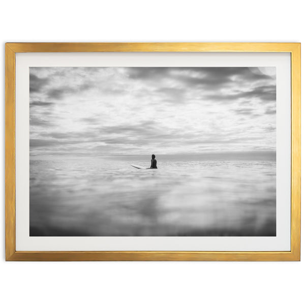 a black and white photo of a person on a surfboard