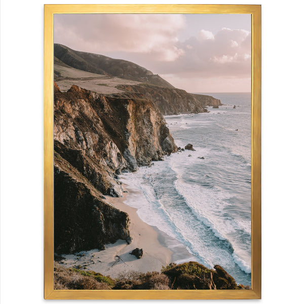 a picture of a beach with a cliff in the background