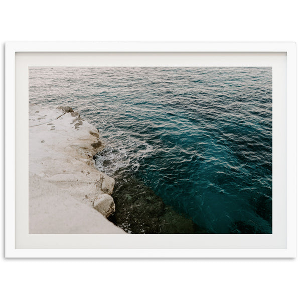 a picture of a body of water next to a cliff