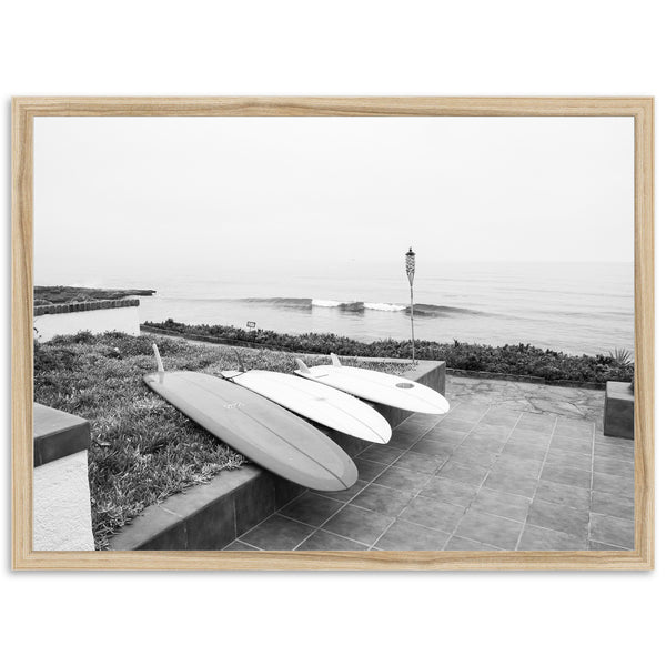 a black and white photo of two surfboards on a wall