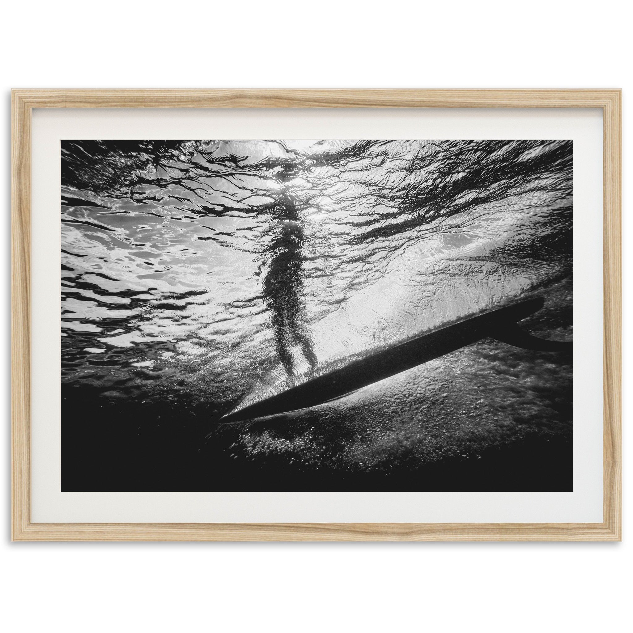 a black and white photo of a person on a surfboard