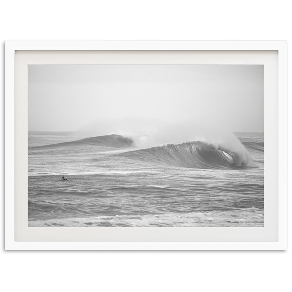 a black and white photo of a large wave