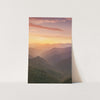 a picture of a mountain range with a sunset in the background