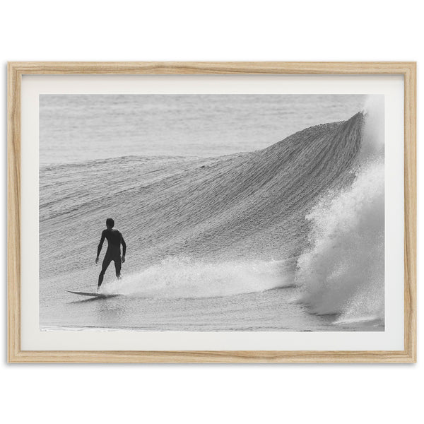 a man riding a wave on top of a surfboard