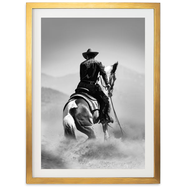 a black and white photo of a cowboy on a horse