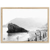 a black and white photo of people on a beach