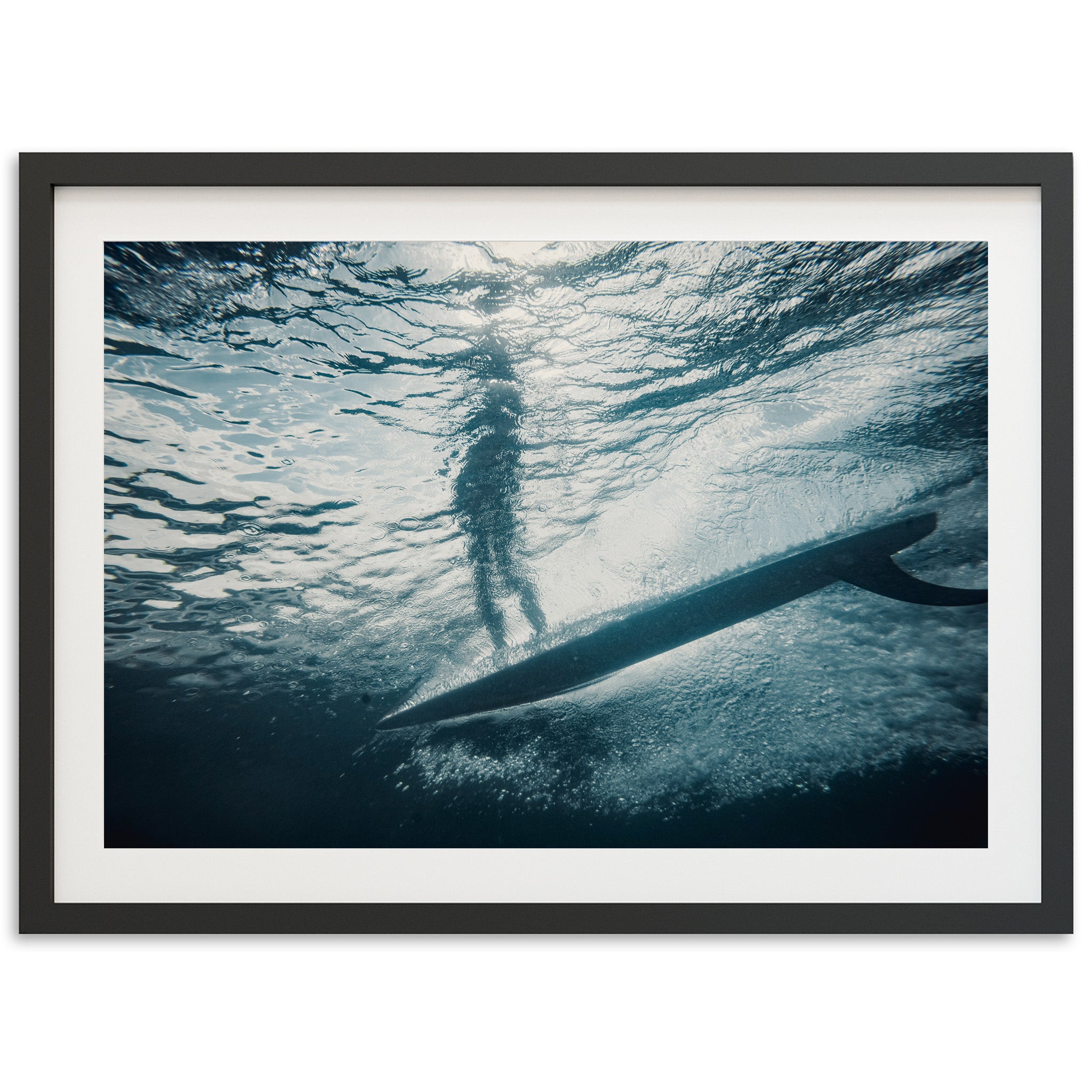 a person standing on a surfboard in the water