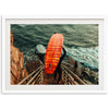 a man carrying a surfboard down a flight of stairs