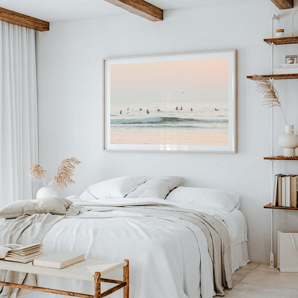 a bedroom with a white bed and a picture on the wall